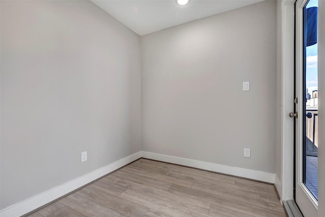 empty room with recessed lighting, baseboards, and light wood finished floors