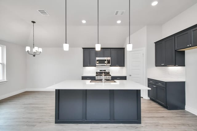 10310 Woodhill Spa Ln, Cleveland, TX 77327 - kitchen featuring appliances with stainless steel finishes, tasteful backsplash, baseboards, light wood finished floors, and light countertops