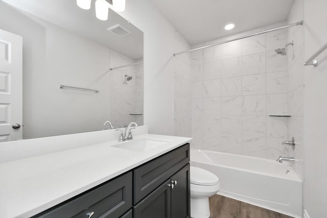 10310 Woodhill Spa Ln, Cleveland, TX 77327 - bathroom featuring toilet, wood finished floors, vanity, shower / tub combination, and recessed lighting