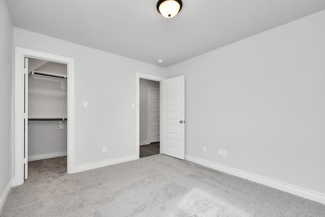 10310 Woodhill Spa Ln, Cleveland, TX 77327 - unfurnished bedroom with carpet, a walk in closet, baseboards, and a closet