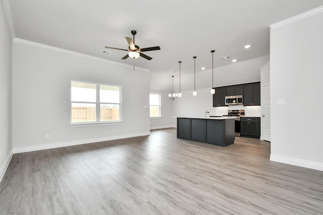 10310 Woodhill Spa Ln, Cleveland, TX 77327 - kitchen with appliances with stainless steel finishes, open floor plan, a ceiling fan, baseboards, and crown molding