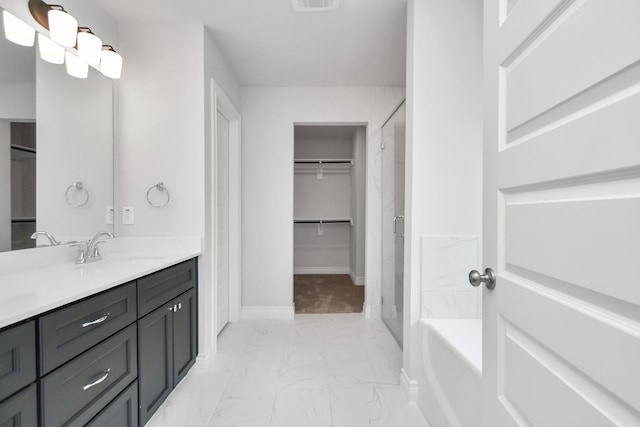 10310 Woodhill Spa Ln, Cleveland, TX 77327 - full bath featuring marble finish floors, a spacious closet, baseboards, vanity, and a shower