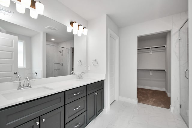 10310 Woodhill Spa Ln, Cleveland, TX 77327 - bathroom featuring a stall shower, marble look tile flooring, a spacious closet, and double vanity