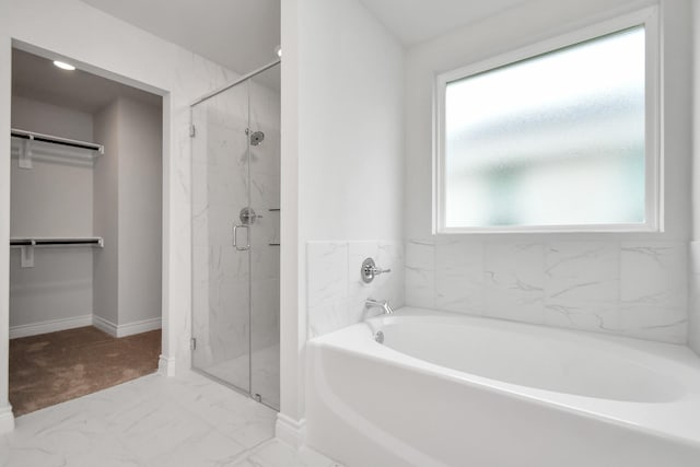 10310 Woodhill Spa Ln, Cleveland, TX 77327 - full bath with a walk in closet, marble finish floors, a shower stall, and a bath
