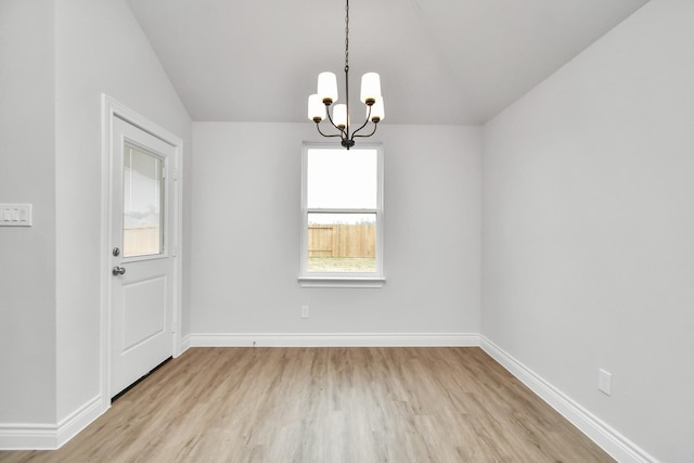 10310 Woodhill Spa Ln, Cleveland, TX 77327 - unfurnished room featuring light wood-style flooring, a chandelier, lofted ceiling, and baseboards