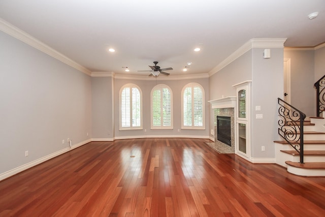 unfurnished living room with stairs, wood finished floors, ceiling fan, recessed lighting, and a premium fireplace