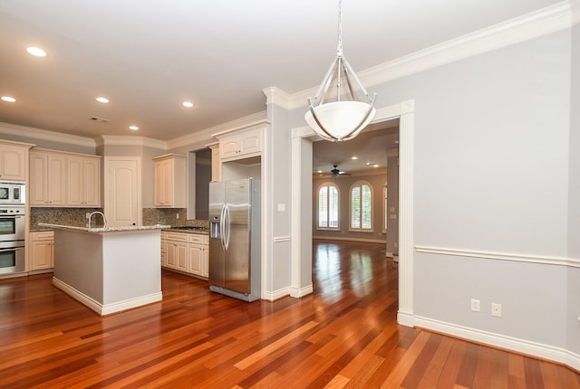 kitchen with decorative backsplash, crown molding, appliances with stainless steel finishes, a sink, and dark wood-type flooring