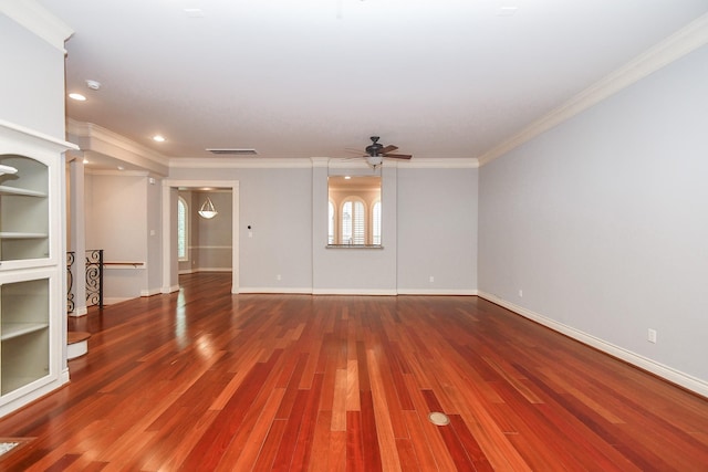 unfurnished living room with visible vents, ornamental molding, wood finished floors, baseboards, and a ceiling fan