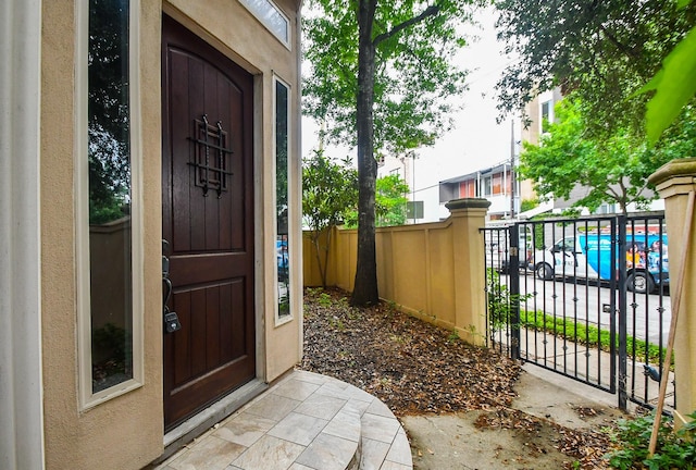 view of exterior entry featuring fence