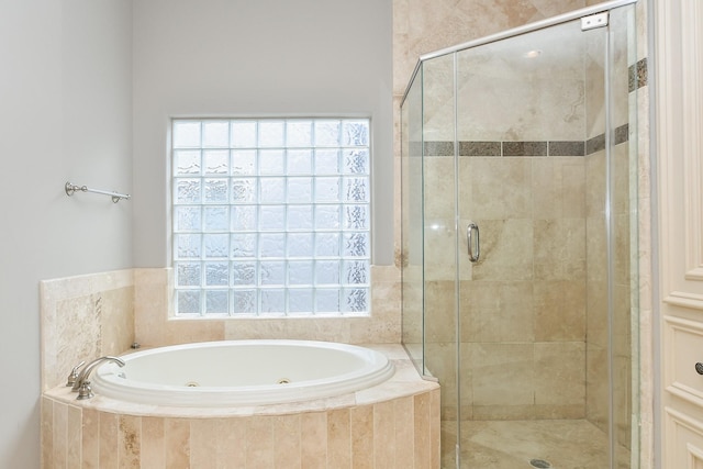 full bath with a tub with jets and a stall shower