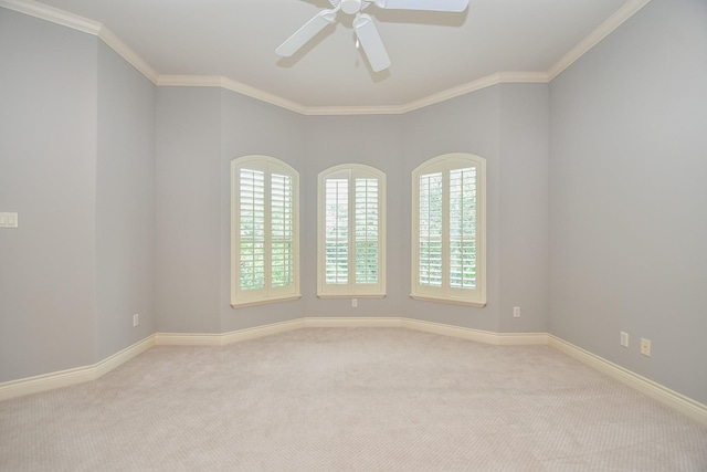 carpeted empty room featuring baseboards, ornamental molding, and ceiling fan