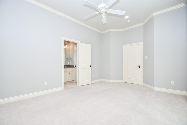 unfurnished bedroom with crown molding, baseboards, light colored carpet, and ensuite bath