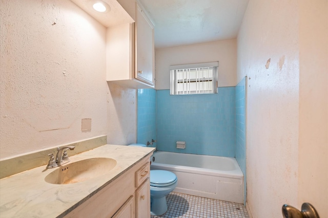 bathroom with tile patterned flooring, vanity, toilet, and a washtub