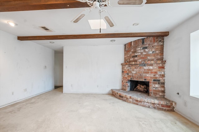unfurnished living room with carpet flooring, ceiling fan, visible vents, and beamed ceiling