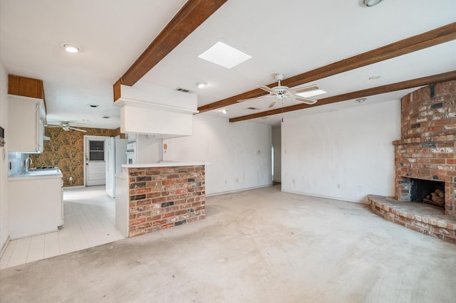 unfurnished living room with visible vents, light carpet, a fireplace, beamed ceiling, and a ceiling fan