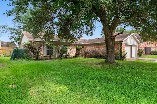 ranch-style house featuring brick siding, a front lawn, an attached garage, and fence