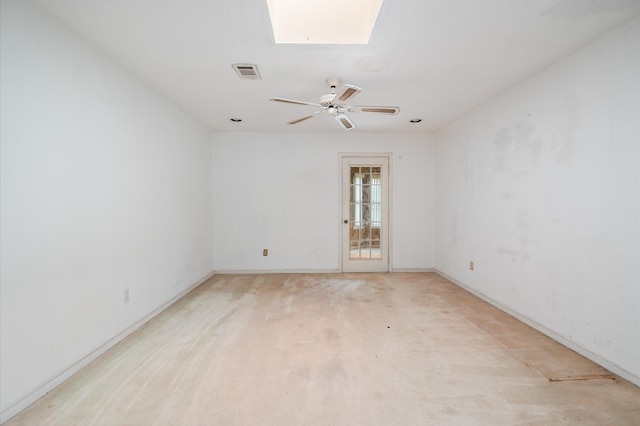 spare room featuring visible vents, a ceiling fan, baseboards, and a skylight