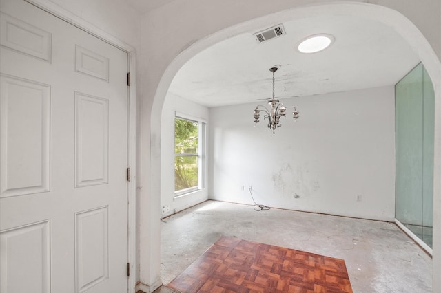 interior space with visible vents, arched walkways, and a notable chandelier
