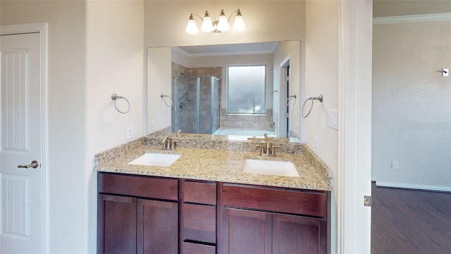 full bath featuring a sink, crown molding, a stall shower, and a garden tub