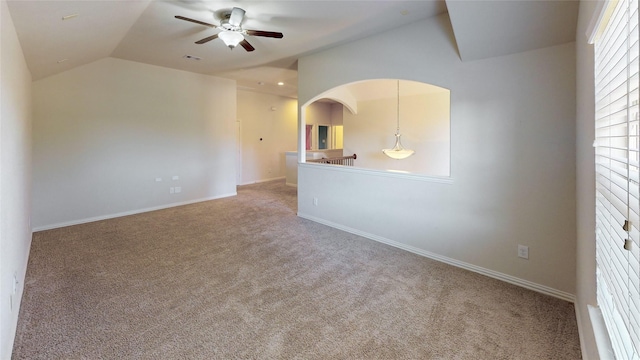 unfurnished room with baseboards, ceiling fan, carpet flooring, and lofted ceiling