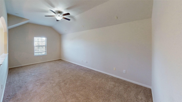 additional living space with carpet floors, baseboards, ceiling fan, and vaulted ceiling