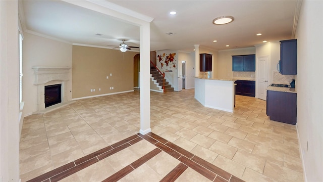 24129 Auburn Falls Ln, Porter, TX 77365 - kitchen featuring open floor plan, tasteful backsplash, a ceiling fan, a fireplace with raised hearth, and baseboards