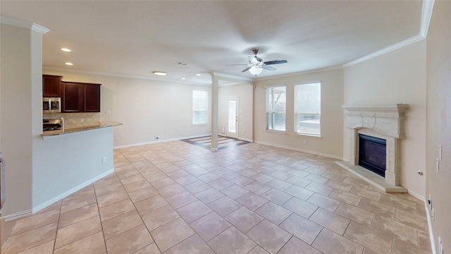 24129 Auburn Falls Ln, Porter, TX 77365 - unfurnished living room with crown molding, a ceiling fan, a glass covered fireplace, light tile patterned floors, and recessed lighting