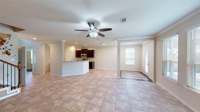 24129 Auburn Falls Ln, Porter, TX 77365 - unfurnished living room with ceiling fan, arched walkways, stairs, crown molding, and light tile patterned flooring