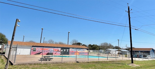view of swimming pool featuring fence