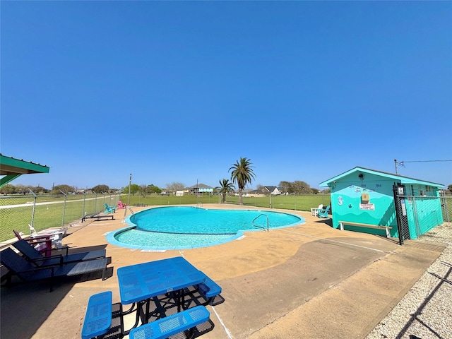 view of swimming pool featuring fence, a patio area, and a fenced in pool