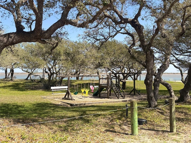 view of property's community featuring a water view, a yard, and playground community