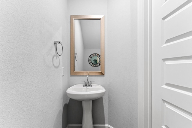 bathroom featuring a textured wall
