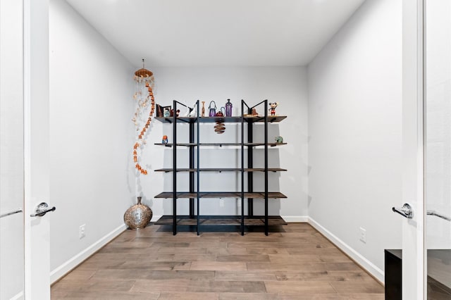 interior space featuring baseboards and wood finished floors