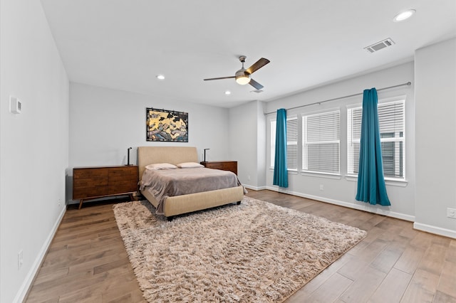 bedroom with baseboards, visible vents, and light wood-style flooring