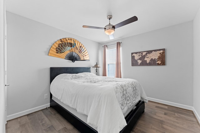 bedroom with baseboards, ceiling fan, and wood finished floors