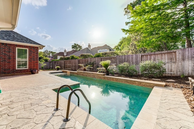 view of pool featuring a fenced backyard, a fenced in pool, and a patio area