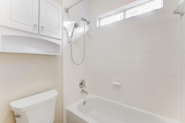 bathroom with bathtub / shower combination and toilet