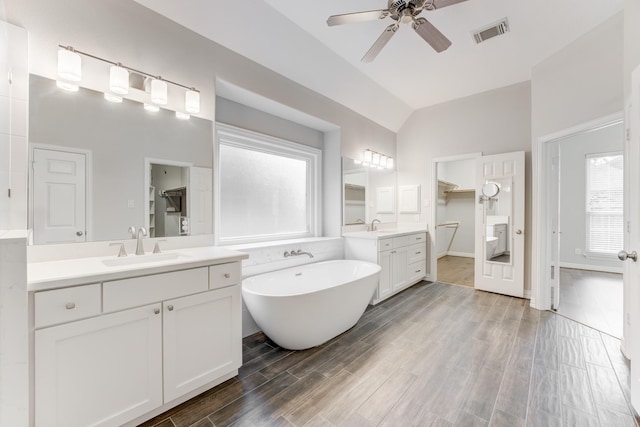 full bathroom featuring a sink, ceiling fan, lofted ceiling, and visible vents