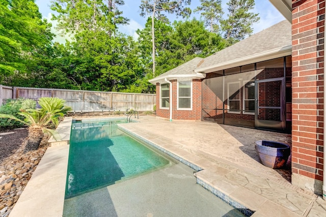view of swimming pool with a fenced in pool, a fenced backyard, and a patio area
