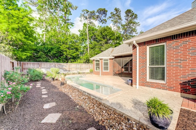 view of swimming pool featuring a fenced in pool, a fenced backyard, and a patio area