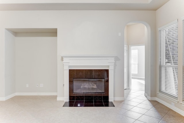 details with arched walkways, baseboards, and a fireplace