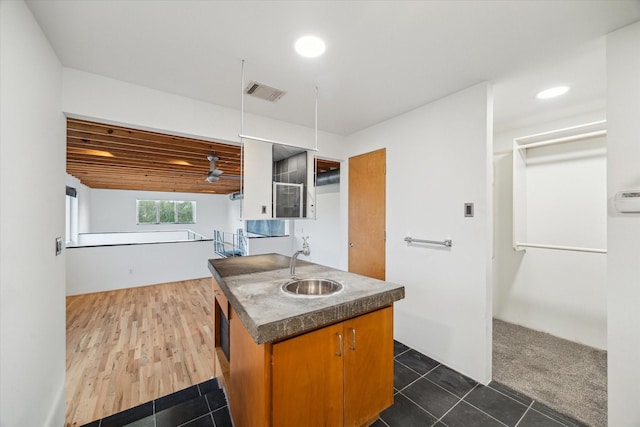 kitchen featuring visible vents, dark countertops, a sink, dark tile patterned flooring, and recessed lighting