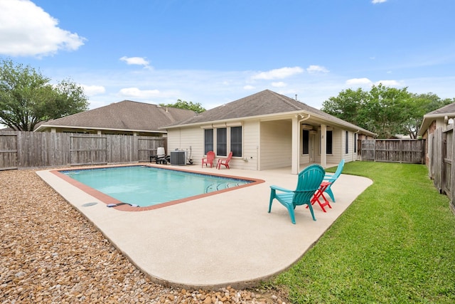 view of pool featuring a yard, a fenced backyard, a patio area, and central air condition unit