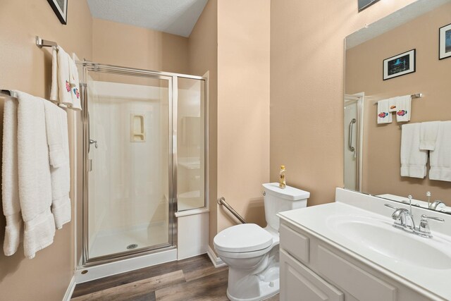 2220 W Marsala Dr, Pearland, TX 77581 - bathroom featuring vanity, a stall shower, toilet, and wood finished floors