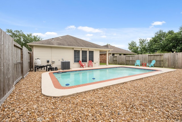 view of swimming pool with central air condition unit, a fenced backyard, and a patio area
