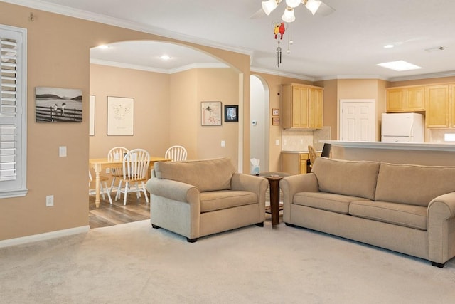 2220 W Marsala Dr, Pearland, TX 77581 - living room with crown molding, arched walkways, a ceiling fan, and light colored carpet
