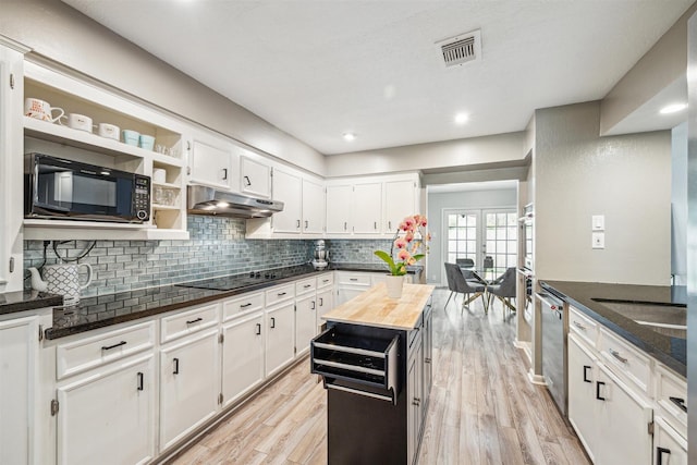14123 Hillvale Dr, Houston, TX 77077 - kitchen with open shelves, white cabinetry, under cabinet range hood, butcher block counters, and black appliances