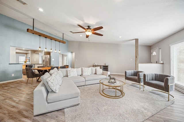 14123 Hillvale Dr, Houston, TX 77077 - living area with a ceiling fan, baseboards, visible vents, and light wood finished floors