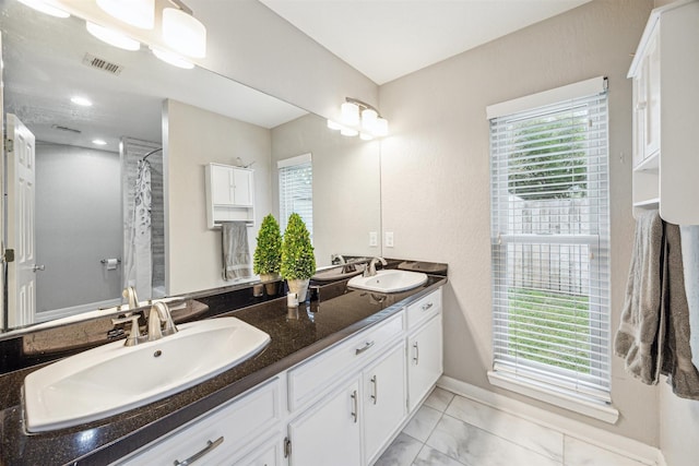 14123 Hillvale Dr, Houston, TX 77077 - full bath featuring a sink, a wealth of natural light, and visible vents