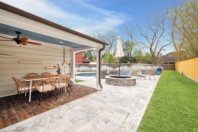 14123 Hillvale Dr, Houston, TX 77077 - view of patio / terrace featuring a fenced backyard, outdoor dining space, ceiling fan, and an outdoor fire pit